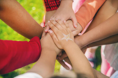 Children folded their hands together play street